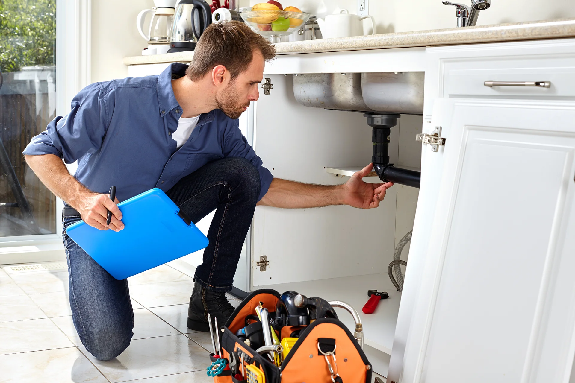 Plumber inspecting connected plumbing system